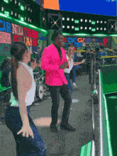 a man in a pink jacket is dancing in front of a sign that says carolina