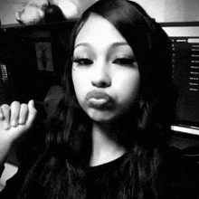 a black and white photo of a young woman making a funny face