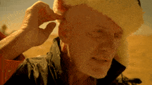 a man wearing a santa hat adjusts his ear buds