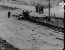 a black and white photo of a train going down a track .
