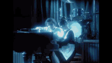 a person playing a piano with a drum set in the back
