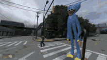 a blue stuffed animal is standing in the middle of a street with the number 90 on the bottom of the screen