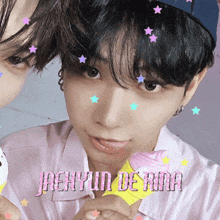 a close up of a person 's face with jaehyun de ara written in pink