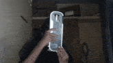 a person is holding a piece of electronics in front of their face