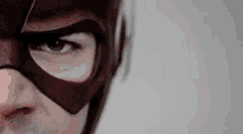 a close up of a man wearing a mask and a helmet .