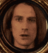 a close up of a man 's face in a round frame