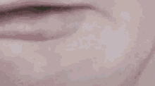 a close up of a person 's mouth with a white tooth in it