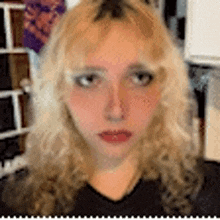 a close up of a woman 's face with blonde hair and red lips .