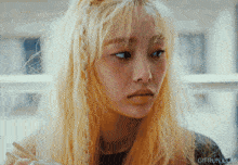 a close up of a woman 's face with the website gifrun.com visible