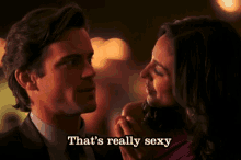 a man and a woman are looking at each other with the words that 's really sexy written below them