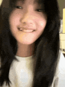 a close up of a girl 's face with a white shirt on