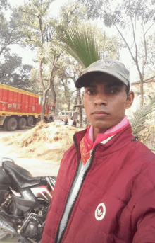 a man wearing a red jacket with the word adidas on the front