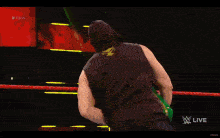 a wrestler is carrying a green box that says money in the bank