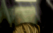 a person 's head is visible in a dark room