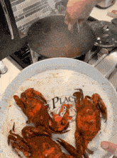crabs are being cooked on a plate that says " crab place "
