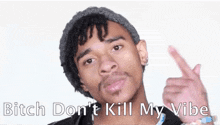 a man in a beanie is pointing at the camera with his finger .