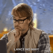 a man wearing glasses and a plaid vest says lance no way