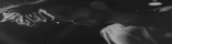 a black and white photo of a man 's face in a room .