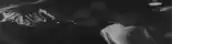 a black and white photo of a man 's face in a room .