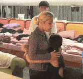a woman hugging another woman in front of a mirror