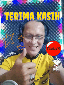 a man wearing headphones gives a thumbs up in front of a sign that says " terima kasih "