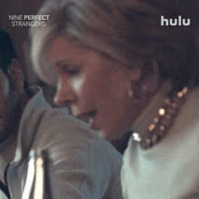 a hulu ad for nine perfect strangers shows a woman kissing a man