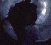 a person is standing in a dark room with a purple background