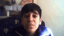 a young boy making a funny face in front of a bag of family friendly candy