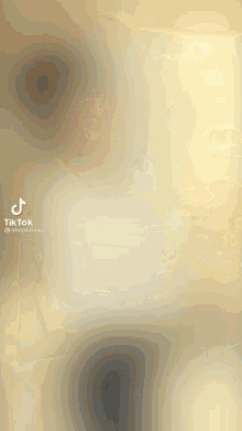 a blurred image of a person 's torso with a tik tok logo on the bottom