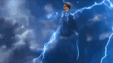 a woman is being struck by lightning in a blue sky