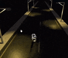 an aerial view of a car driving down a street at night