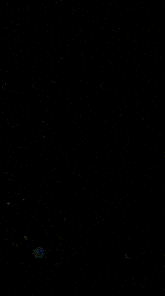 green smoke is coming out of a bottle on a black background .