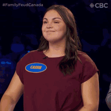 a woman with the name cassie on her shirt applauds