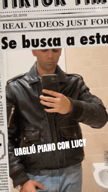 a man is taking a picture of himself in front of a newspaper that says real videos just for