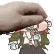 a hand is holding a cartoon character with a knife .