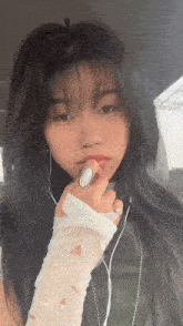 a woman wearing a ring on her finger is taking a selfie