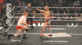 two wrestlers are in a wrestling ring with the letters n on the bottom