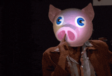 a woman wearing a pig mask giving a thumbs up in front of a sign that says that 's
