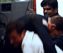 a man is carrying another man on his back in a blurry picture