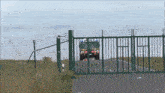 a fence with barbed wire and a truck that says ' polizei ' on the side