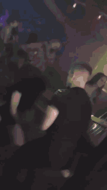 a blurry picture of people dancing at a party