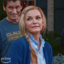 a man wearing a shirt that says claus custom furniture rests behind a woman wearing a blue cardigan