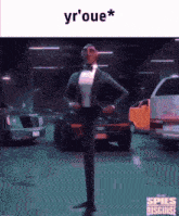 a man in a tuxedo and bow tie is standing in a parking lot with cars .