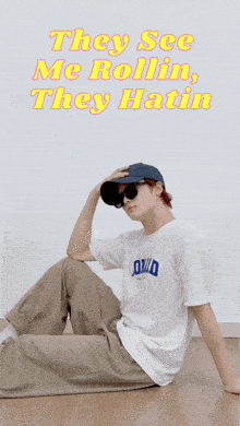 a person wearing sunglasses and a hat with the words they see me rollin they hatin behind them