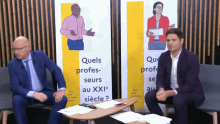 two men are sitting in front of a sign that says " quels profes-seurs au xxi "
