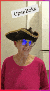 a woman wearing a pirate hat and sunglasses with a sign that says openbokk