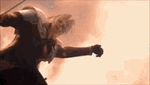 a man in a knight 's armor is flying through the air with a sword .