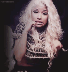 a woman with long blonde hair is making a funny face