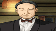 a man in a tuxedo and bow tie is smiling
