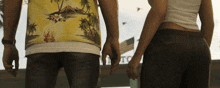 a man in a hawaiian shirt holds a woman 's hand in front of a sign that says gto